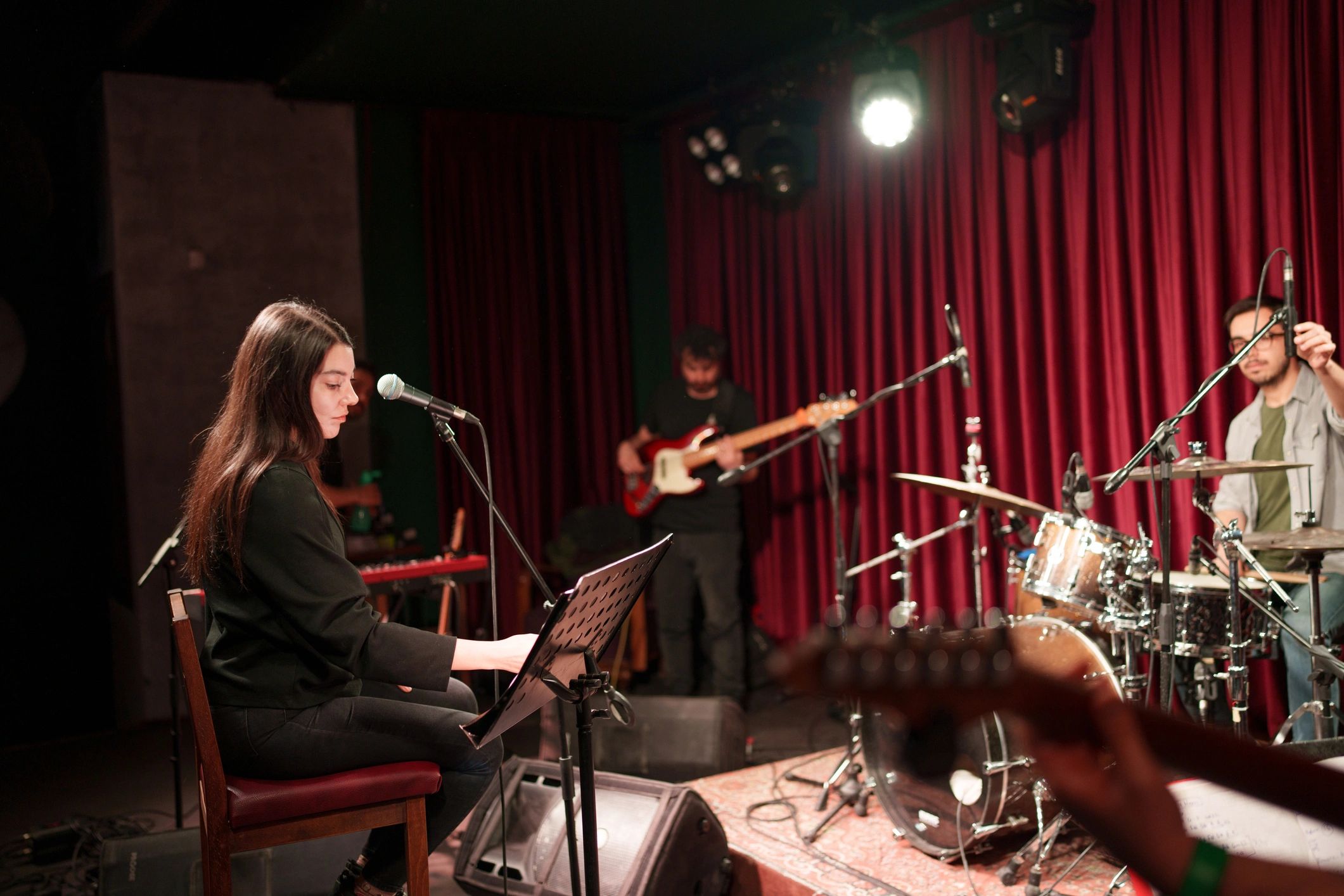 Band working through a live rehearsal on stage